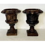 A pair of 19th century Scottish treacle glazed urns depicting chariots with relief moulded