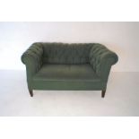 A small green Chesterfield sofa, approximate length 142cm.