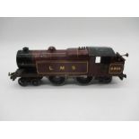 An unboxed Hornby O gauge clockwork 4-4-2 LMS locomotive in crimson (No. 6954)