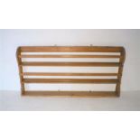 An antique pine wall hanging plate rack, length 151.5cm, height 74cm.