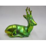 A Zsolnay Pecs figure of a recumbent stag with blue-green eosin glaze, signed Linko Q (scratch to