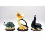 Three reproduction Guinness ceramic money boxes in the form of a pelican, seal and a tortoise.