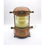 A copper ships lantern marked 'J. H. Peters & Bey, Hamburg 11', converted to electric