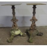 A pair of cast iron table bases featuring stylised dolphins. Height 68cm