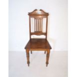 A turn of the century oak hall chair.