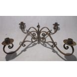 A wrought iron four branch chandelier