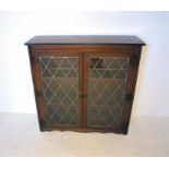 An oak lead glazed display cabinet, with two doors, length 103cm, height 104cm.