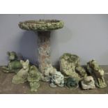 An assortment of garden ornaments in the form of animals also includes a bird bath.