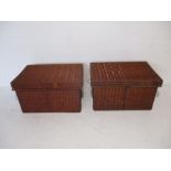 A pair of vintage lidded wicker baskets
