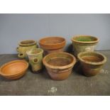 Seven large terracotta pots including two strawberry pots.