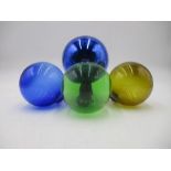 A blue glass witches ball plus three coloured glass fishing floats.