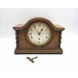 An oak cased mantel clock, with key.