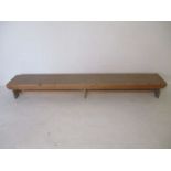 An industrial wooden bench - from Axminster Carpets - length 270cm, height 30cm