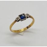 An 18ct gold Art Deco three stone ring set with diamonds and sapphire