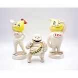 Two Esso metal money boxes along with a Michelin Man metal money box.