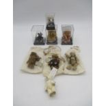 A collection of four cased "World of Miniature Bears" teddy bears, all with certificate of