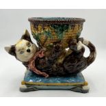 A Minton majolica jardiniere in the form of a cat playing with a wicker basket on cushion, height 27