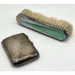 A hallmarked silver cigarette case (53.2g) along with an enamelled silver brush with Art Deco