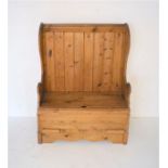 An antique pine settle, with lift up seat, length 90cm, height 120cm.