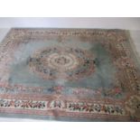 A large Chinese rug, tassels missing from one end. 272cm x 364cm.
