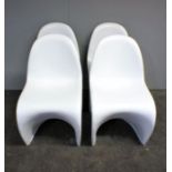 A set of four white Vitra Panton style chairs.