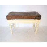 A butcher's block, on painted base, length 124cm, width 60cm, height 90cm.