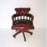 A leather button-back Captain's chair.