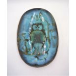 A blue glazed studio pottery dish decorated with an owl, signed Paul Whatley.