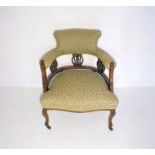 An Edwardian upholstered tub chair.