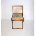 An Edwardian mahogany bedroom chair with cross frame stretcher and tapestry seat.