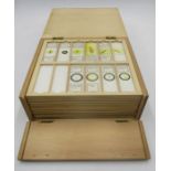 A boxed set of vintage microscope slides, some named