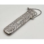 A hallmarked silver needle case with repousse decoration