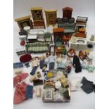 A collection of dolls house furniture and accessories including bookcase, washing machine, sofas,