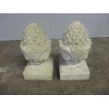 Two reconstituted stone finials in the form of pineapples, height 34cm