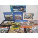 A collection of various jigsaw puzzles mainly relating to trains, along with a Revell Northsea