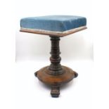 A Victorian rosewood upholstered piano stool.
