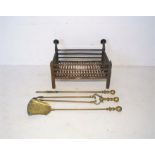 A cast iron fire grate along with three brass fire irons.