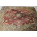 An Eastern style red ground rug. (In need of cleaning) 358cm x 276cm
