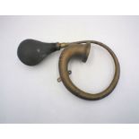 An antique Indian brass car horn, marked 'Deluxe'.