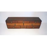 A mahogany small set of eight drawers, length 78.5cm, height 22cm.