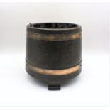 A brass bound wooden barrel garden planter.