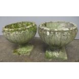 A pair of weathered reconstituted stone garden urns. Approx height 34cm.
