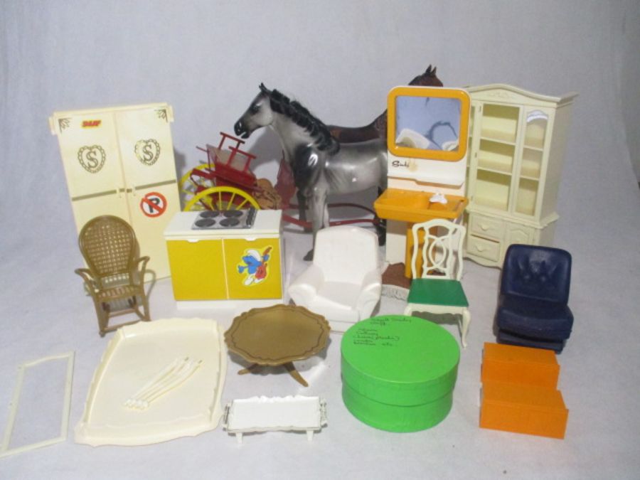 A collection of Sindy Doll accessories including furniture, horses and car, shoes, cutlery,