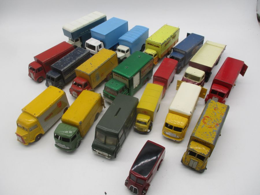 A collection of playworn die-cast vans and trucks including Dinky Toys, Corgi Toys, Lledo