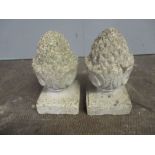 Two reconstituted stone finials in the form of pineapples, height 34cm