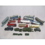 A collection of playworn die-cast car transporters, tankers and army vehicles including Dinky,