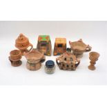 A quantity of Omani and Dhofari handcrafted terracotta frankincense burners, along with a jar of