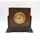 A Bestone walnut veneered mantel clock/valve radio, back loose but present.