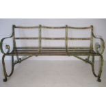 A Victorian strap work bench with curved back rests.