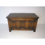 An oak coffer with scroll detailing, length 91cm, height 50cm.